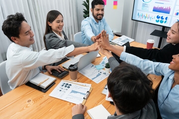 Diverse business team celebrate successful meeting with high-fives and expressions of happiness in corporate office meeting represent unity success and professional integrity. Concord