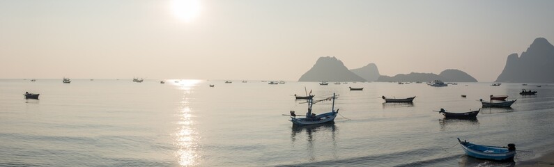 Panoramic beautiful sunrise on the ocean.  Boats and tropical sea. Beautiful landscape from the viewpoint at Prachuap Bay in Prachuap Khiri Khan Province, Thailand.