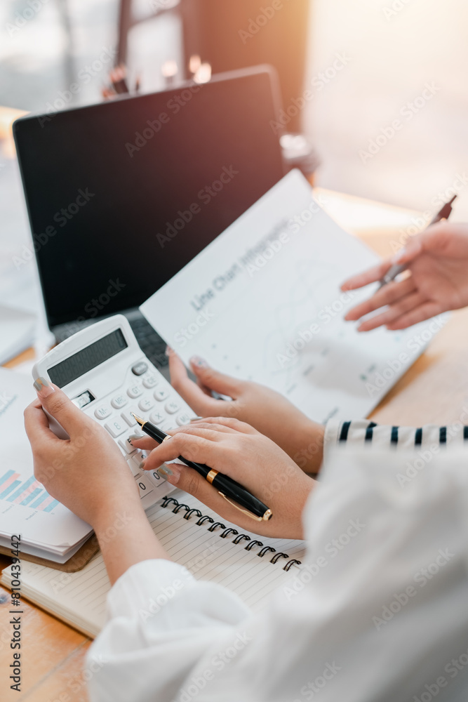 Aufkleber close-up of a professional's hands using a calculator for financial analysis, with charts and a lapt