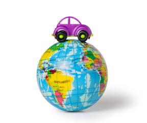 a miniature car on a small globe, travel and tourism concept. Isolated on white background