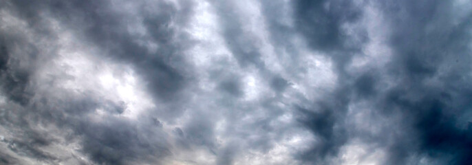 Banner Dramatic dark storm clouds black sky background. Dark thunderstorm clouds rainny season. Panorama Meteorology danger windstorm disasters climate. Dark cloudscape storm cloud with copy space.