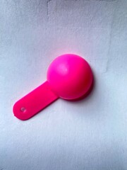 pink spoon on white background