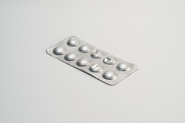 Used packs of pills on white medical table