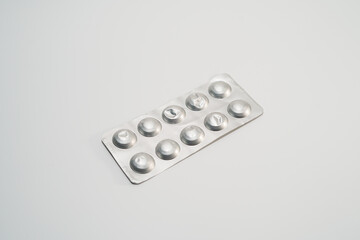 Used packs of pills on white medical table