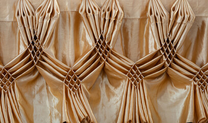 Golden curtains tied with beautiful patterns suitable for hotel events