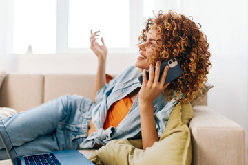 Happy woman using laptop in cozy living room for online freelance work