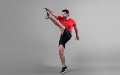 Full body length gaiety shot athletic and sporty young man with fitness in cardio exercise, kicking...