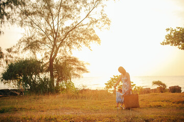 Young mom and her son under the sunset on Phu Quoc island, Vietnam