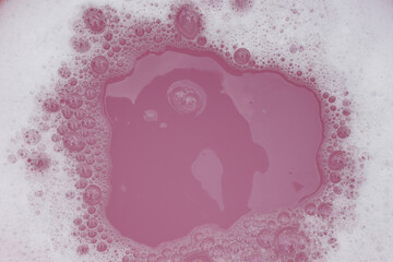 White detergent foam bubble, pink background.