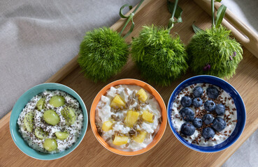 Healthy breakfast options arrangement including cottage cheese with grapes and chia seeds,...
