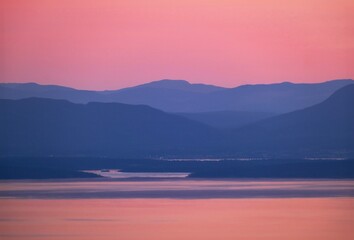 Mountains in the sea at sunset. Pink and blue landscape. Vancouver Island. British Columbia. Canada. View form the Grouse Mountain. 