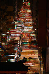 Bird view of Night Market at Temple street full of stalls in Hong Kong at night.