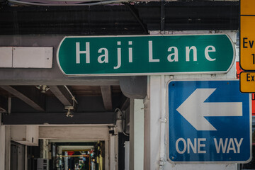 Green Haji Lane Sign with Directional Arrow in Urban Environment in Singapore