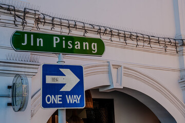 One Way Sign and Jln Pisang Street Name in Urban Setting in Singapore