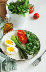 Fresh Spring Salad With Boiled Eggs, Asparagus, and Tomatoes on a Bright Day