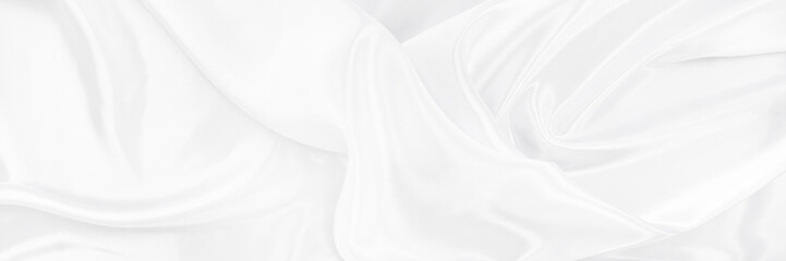 White gray satin texture that is white silver fabric silk background with beautiful soft blur...