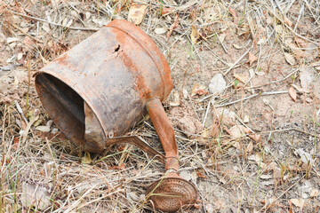 The galvanized watering can was unused and rusted.