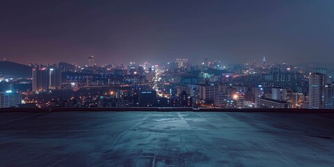 A city skyline at night with a dark sky and a few clouds