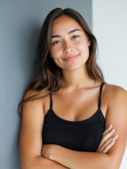 A woman with long hair is smiling and posing for a picture