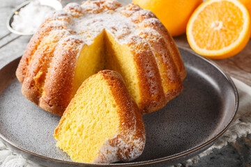 Moist Orange Pound Cake with Orange Zest close-up on a plate on the table. Horizontal
