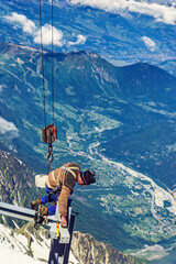 Construction workers on a steel beam in the Alps