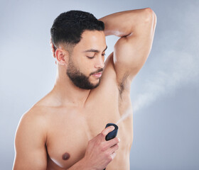 Man, deodorant and spray in studio for hygiene, fragrance and stop sweat for fresh scent by...