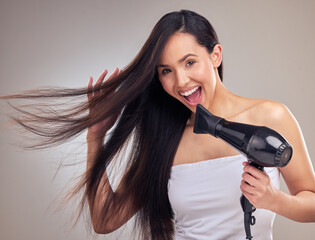 Asian woman, hairdryer and happy with portrait in studio for growth, straighten and brazilian...