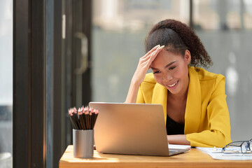 African office worker American working with laptop Tired financial documents having a headache at the office, feeling sick, migraine, feeling pressured, stressed, fatigue, office syndrome concept.
