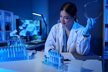 Professional science experts at work Asian female scientist with test tube research in clinical...