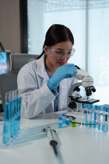 Confident female scientist conducting research in medical laboratory A researcher in the foreground...