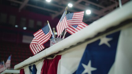 Elections in the United States of America. Close up of table for voting registration with American flags standing at polling place. Presidential race and election coverage. Civic duty and patriotism.