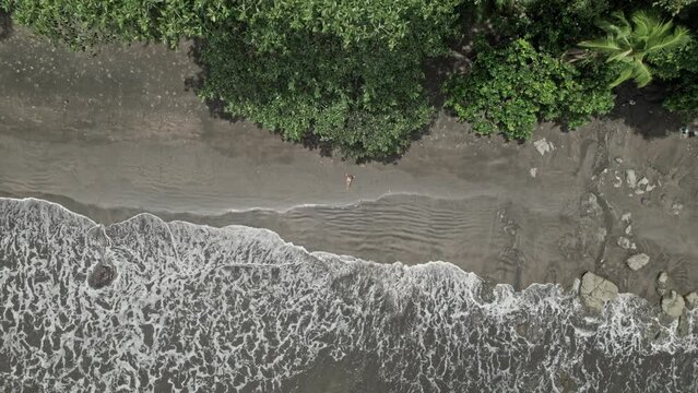 Top view of a woman sunbathing in a wild beach