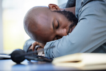 Man, sleeping and tired consultant and desk, lazy employee and burnout for company project with fatigue. Overwhelmed, stress and exhausted worker in call centre, nap and low energy or African person