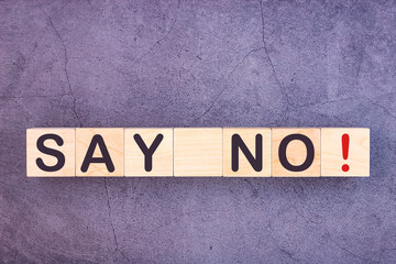 SAY NO word written on wood block on a grey background