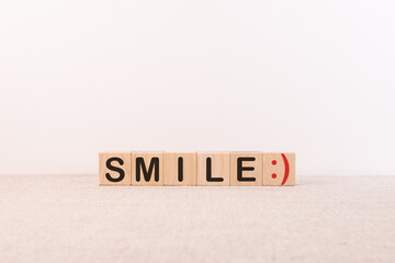 SMILE word concept written on a light table and light background