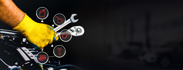 Car maintenance and servicing concept , A mechanic hand using a wrench to fix an automobile , car maintenance virtual screen , horizontal banner with copy space