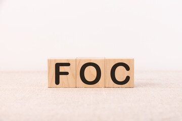 FOC word concept written on a light table and light background