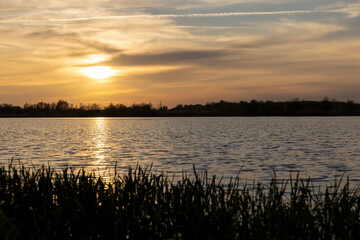 beautiful sky and reflection of the sun and sky in the lake water