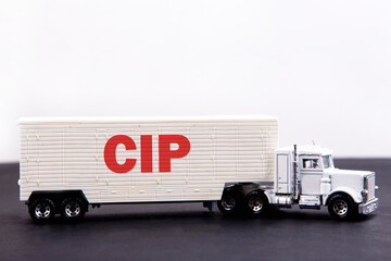 CIP word concept written on board a lorry trailer on a dark table and light background
