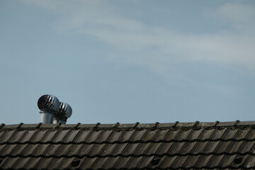 Tiled house roof with chimneys
