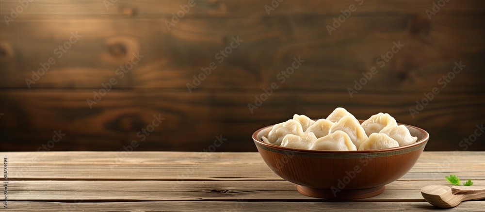 Poster a delicious bowl of dumplings sits on a wooden table with ample copy space for the image