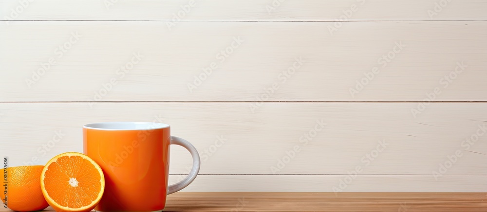 Poster a copy space image of an orange cup sits on a wooden table standing out against a white background
