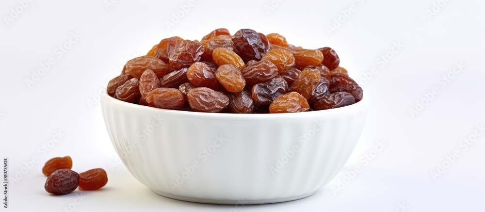 Aufkleber a macro image of a healthy snack consisting of raisins in a bowl placed on a white background provid