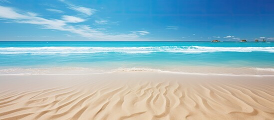 Obraz premium A copy space image on a stunning beach showcases the phrase Out of Office written in sand with the mesmerizing backdrop of blue waves portraying a concept of relaxation