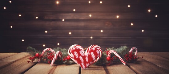A festive Christmas background featuring candy canes arranged in a heart shape The words Best Wishes are written on a wooden table which also offers ample copy space for your own message or image - Powered by Adobe