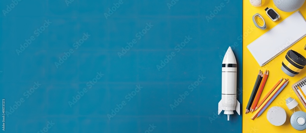 Leinwandbilder the back to school theme features white and yellow school tools and a rocket on a blue background th