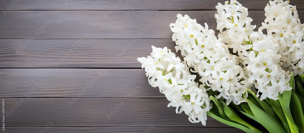 Poster White hyacinths in a bouquet placed on a weathered wood background create a visually captivating copy space image