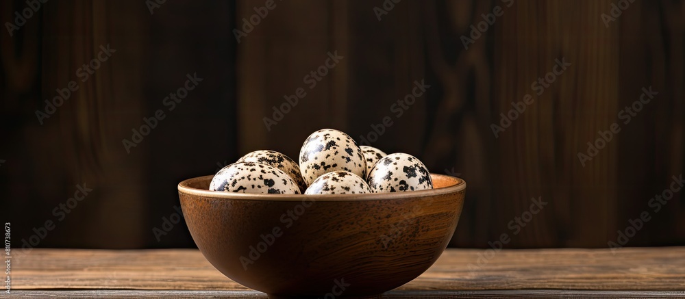 Poster a quail egg is placed in a bowl on a wooden table providing an ample amount of copy space for text o