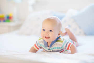 Little baby on white bed