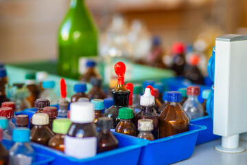 Flasks and test tubes with multi-colored chemical liquids in a laboratory in a clinic. Testing, analysis and research in laboratories. Clinical study.
